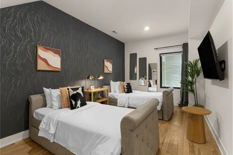 a bedroom with furniture and a flat screen tv