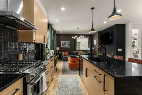 a kitchen with stove a sink and cabinets