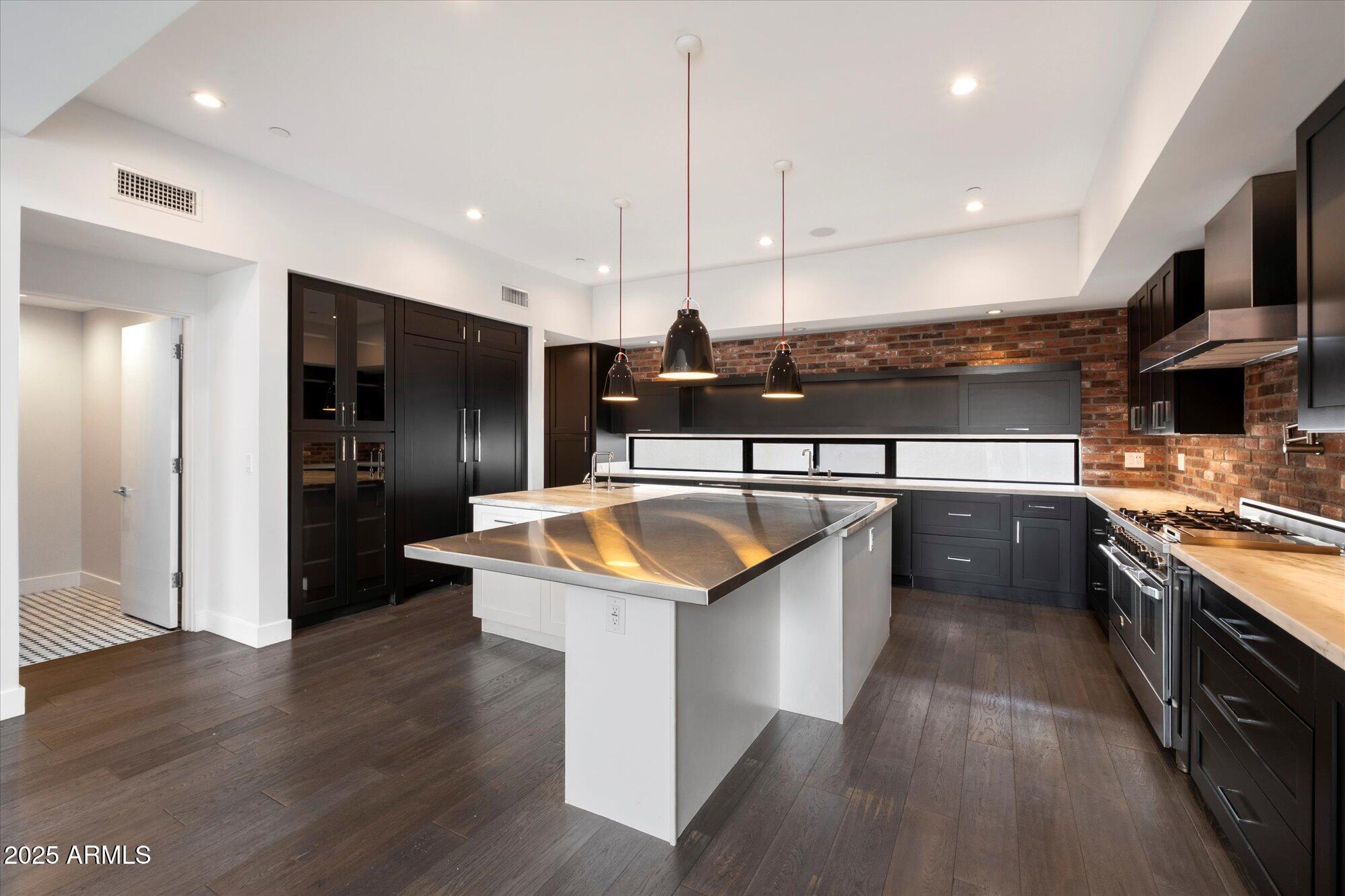 4525 North 36th Way Phoenix, AZ 85018 - Photo 12 of 40 a kitchen with stainless steel appliances granite countertop a sink a stove and a refrigerator