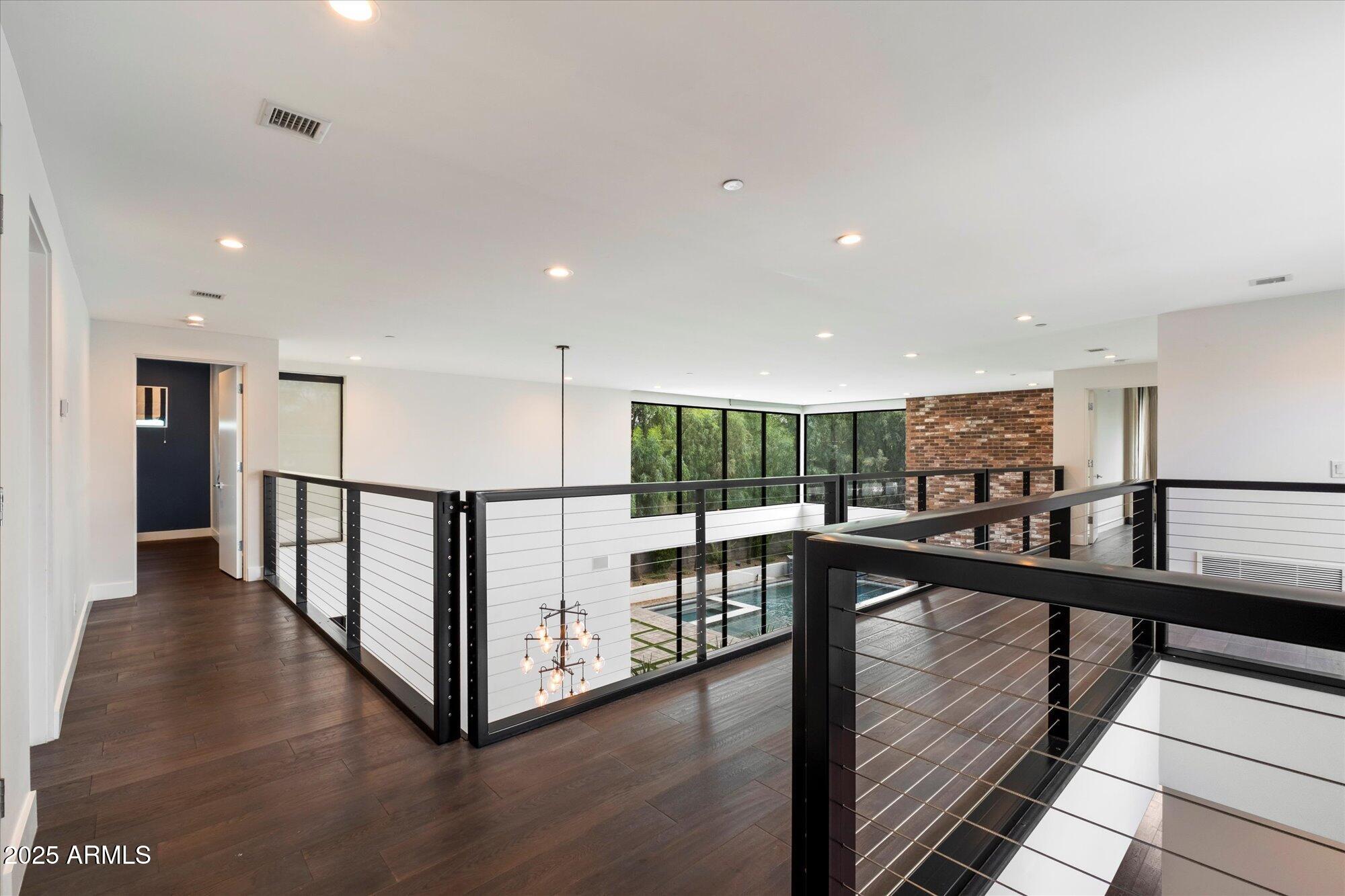 4525 North 36th Way Phoenix, AZ 85018 - Photo 18 of 40 a view of a hallway with wooden floor and stairs