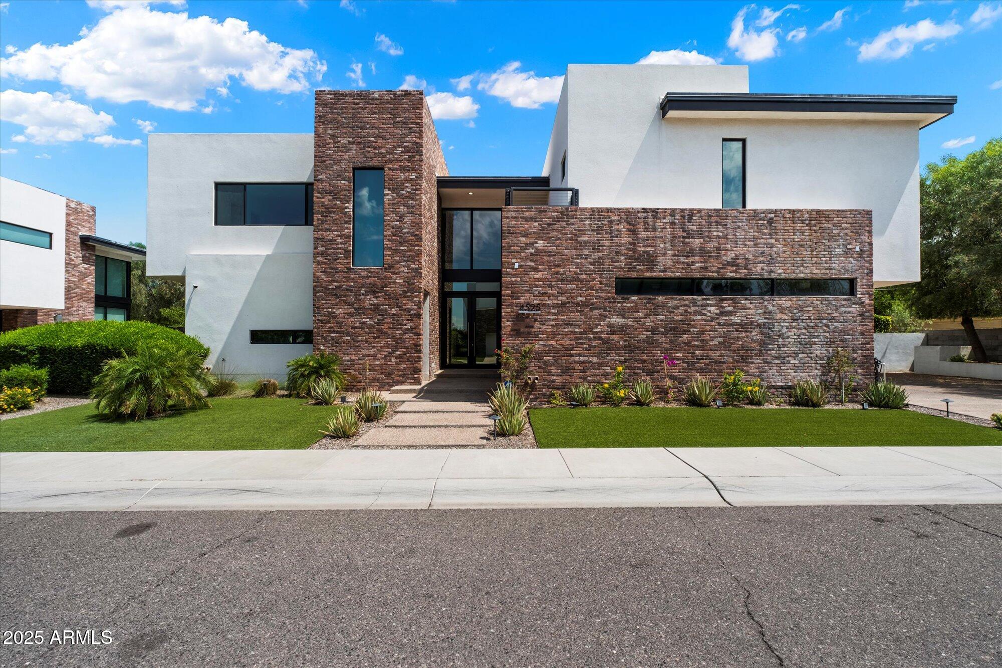 4525 North 36th Way Phoenix, AZ 85018 - Photo 2 of 40 a front view of a house with a garden and yard