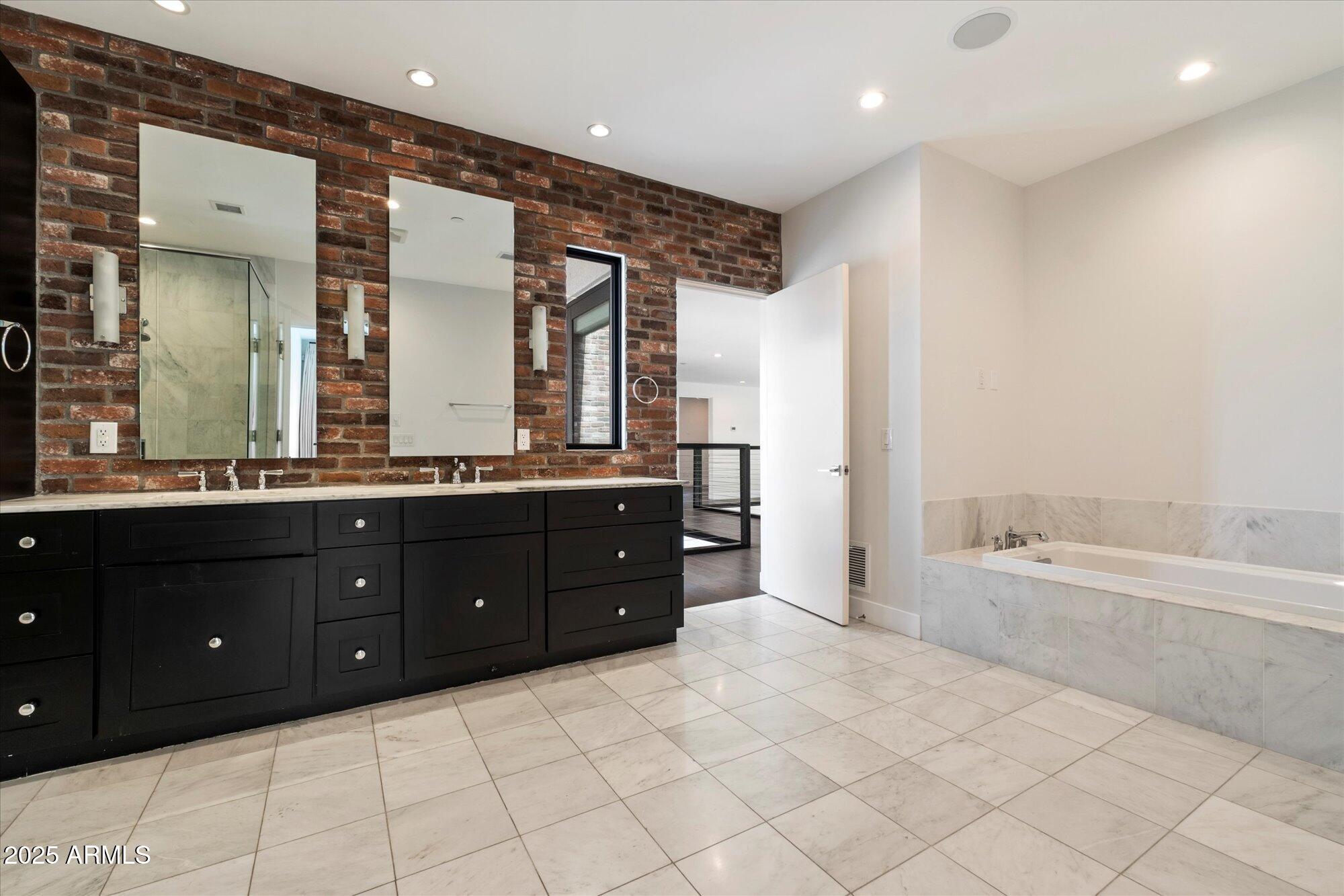 4525 North 36th Way Phoenix, AZ 85018 - Photo 22 of 40 a spacious bathroom with a tub sink and mirror