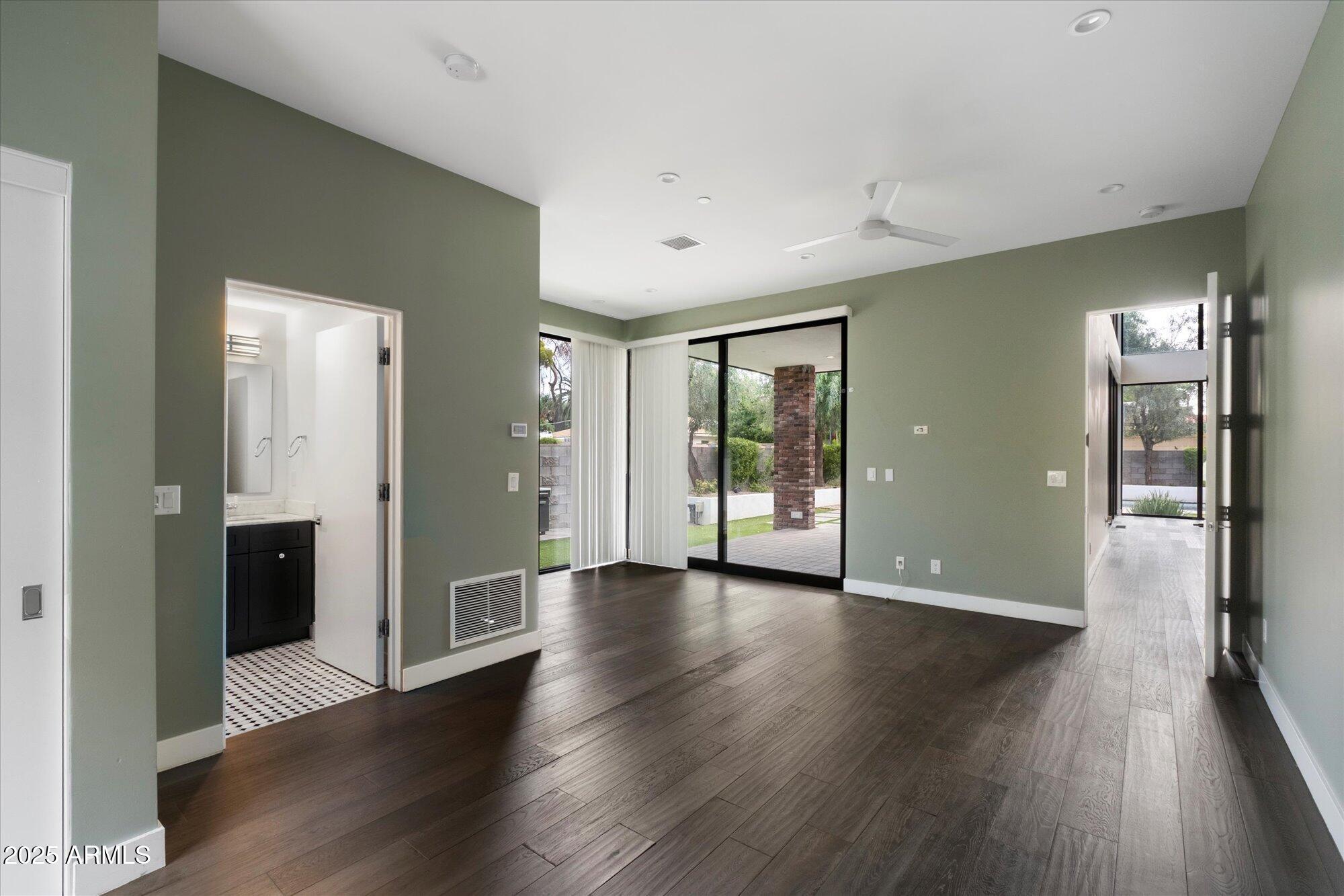 4525 North 36th Way Phoenix, AZ 85018 - Photo 24 of 40 an empty room with wooden floor and windows