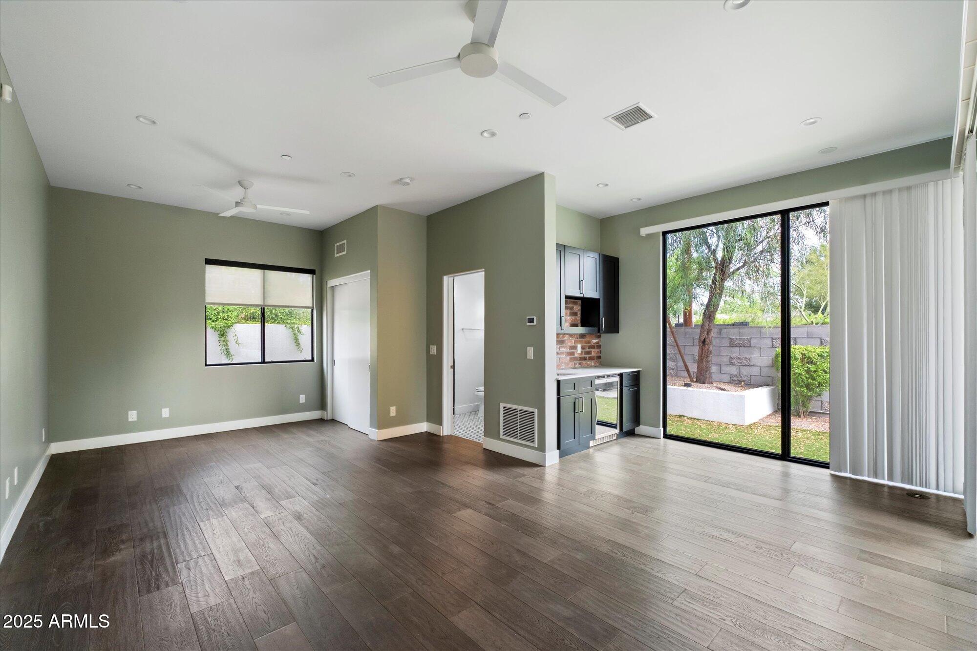 4525 North 36th Way Phoenix, AZ 85018 - Photo 25 of 40 an empty room with wooden floor and windows