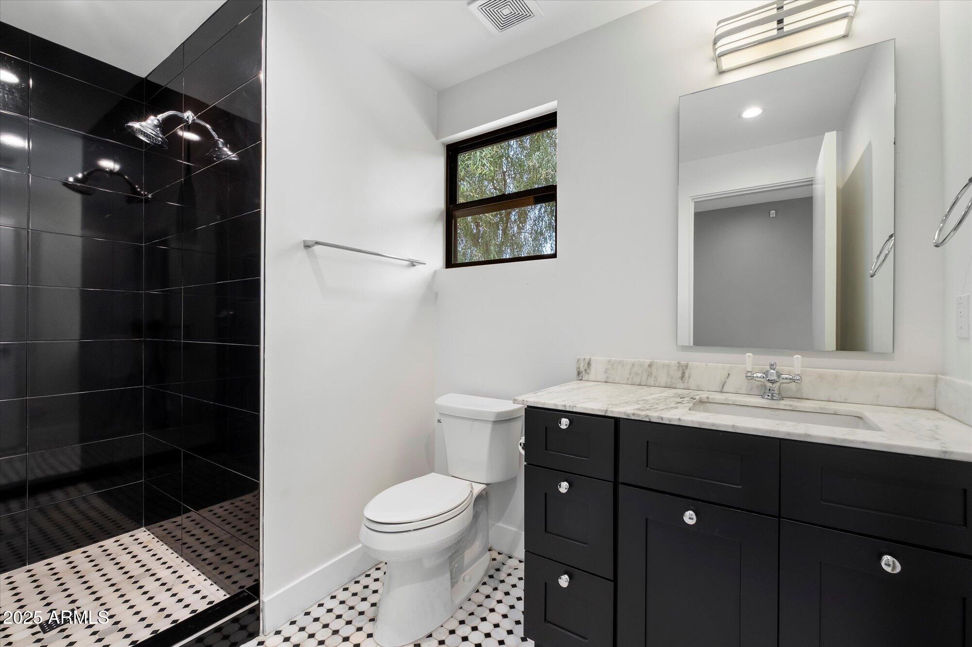 4525 North 36th Way Phoenix, AZ 85018 - Photo 26 of 40 a bathroom with a sink toilet and shower