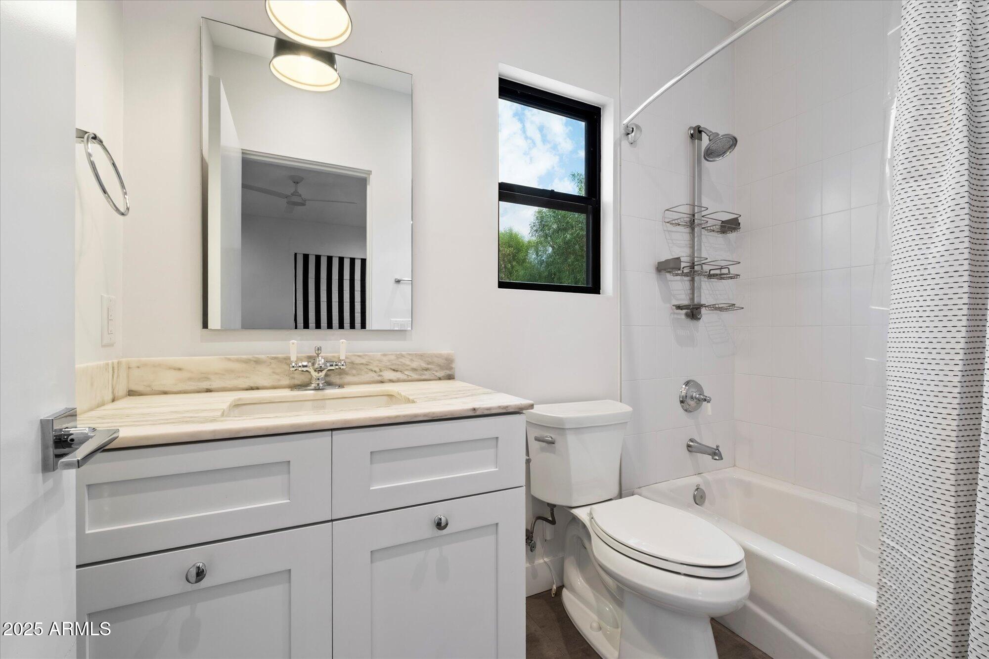 4525 North 36th Way Phoenix, AZ 85018 - Photo 28 of 40 a bathroom with a sink toilet vanity and shower