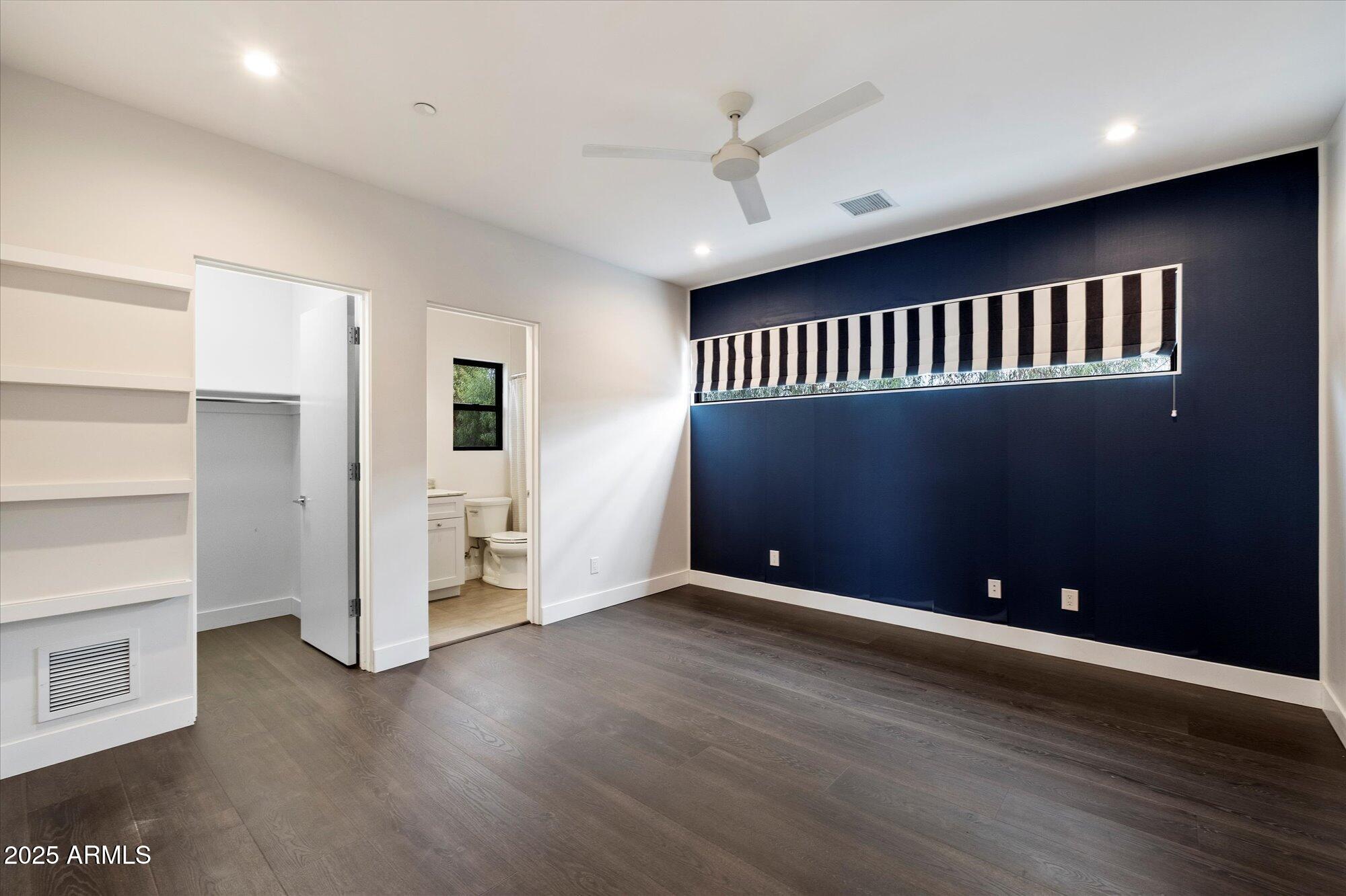 4525 North 36th Way Phoenix, AZ 85018 - Photo 29 of 40 an empty room with wooden floor and windows