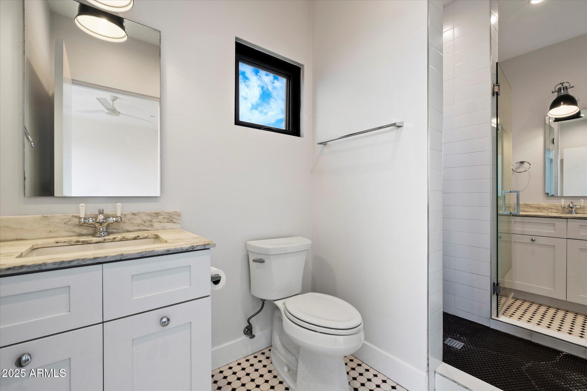 4525 North 36th Way Phoenix, AZ 85018 - Photo 30 of 40 a bathroom with a toilet a sink and a mirror