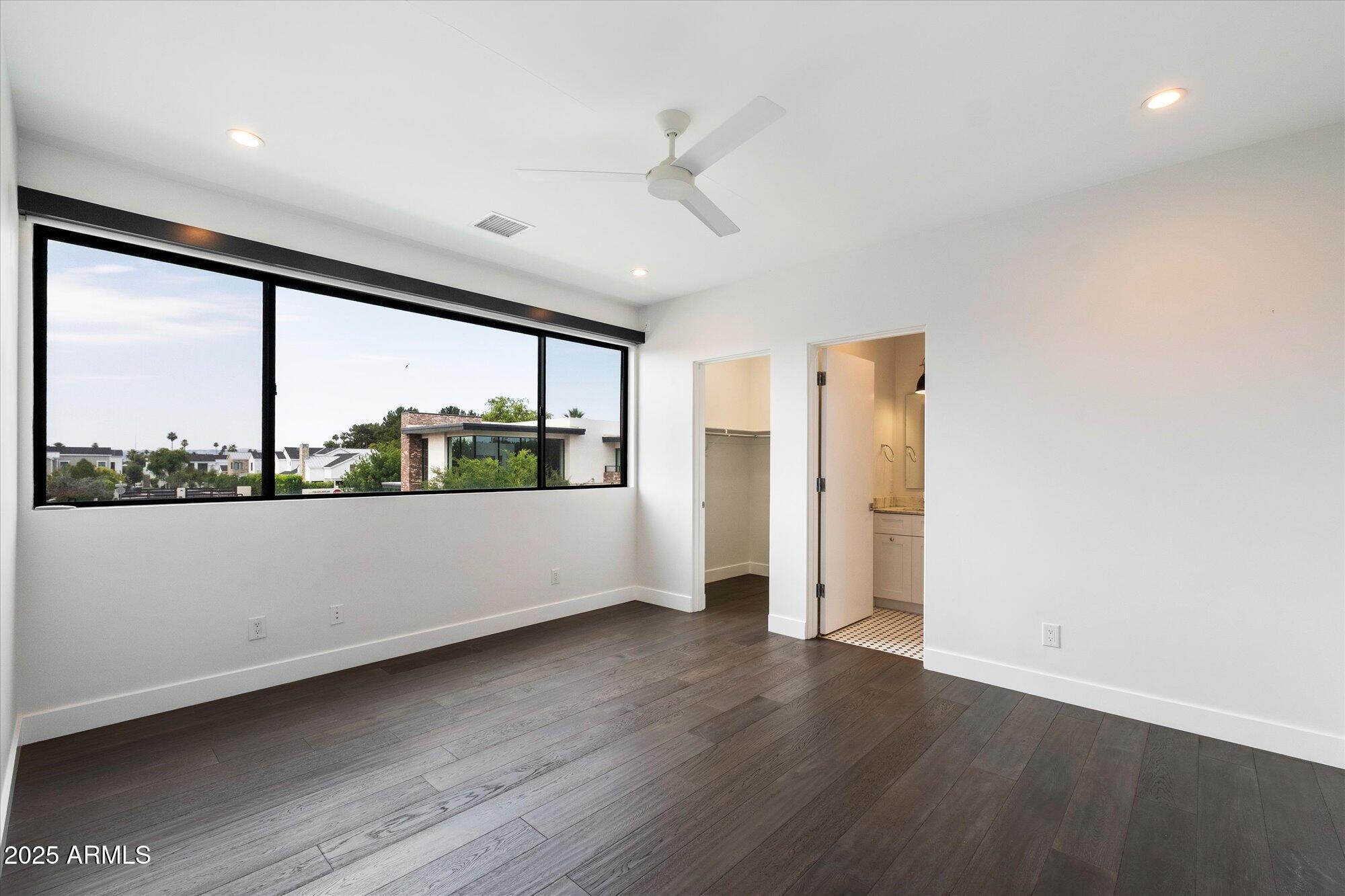 4525 North 36th Way Phoenix, AZ 85018 - Photo 31 of 40 an empty room with wooden floor and large window