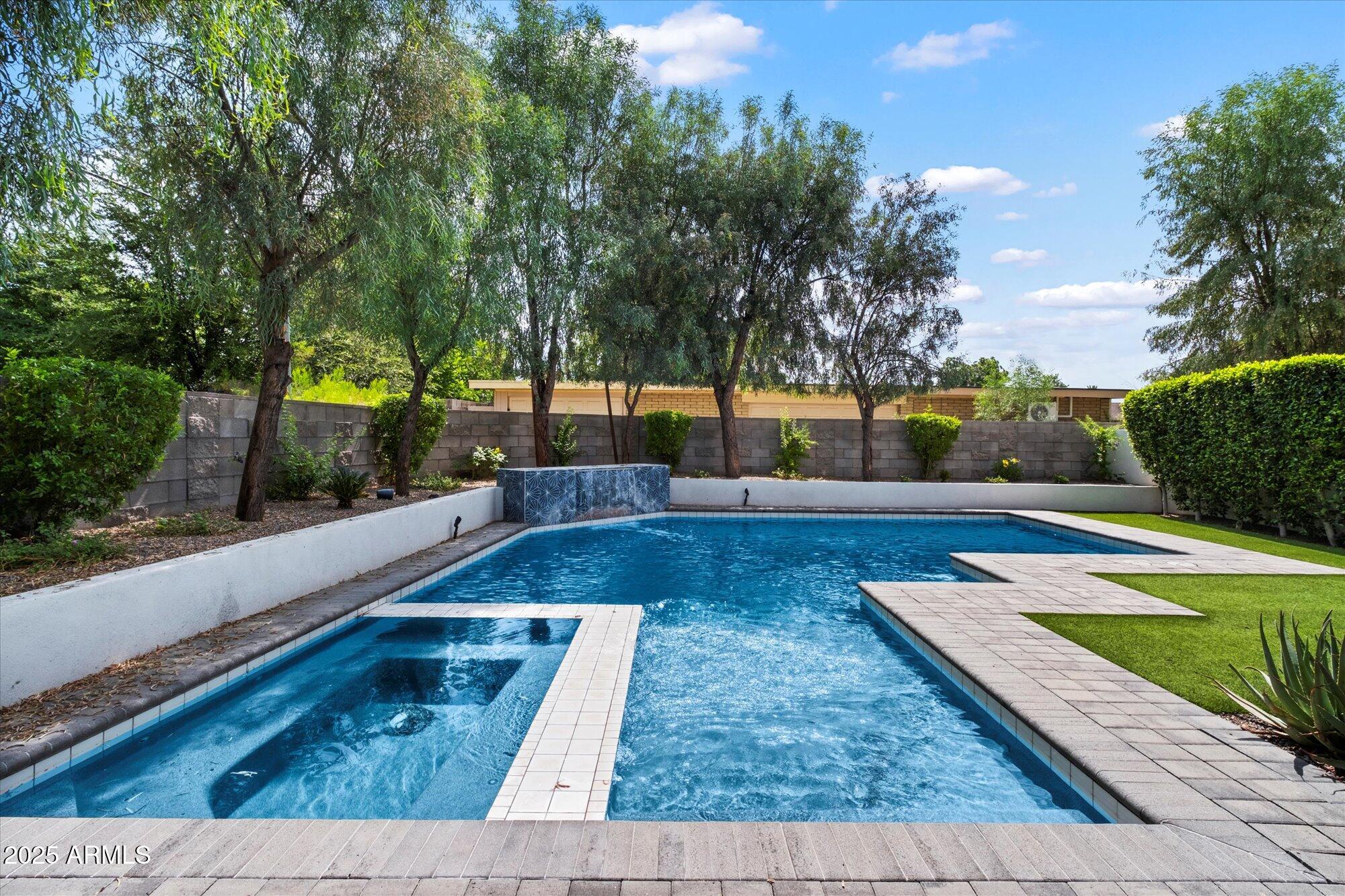 4525 North 36th Way Phoenix, AZ 85018 - Photo 37 of 40 a view of a swimming pool with a patio and a garden