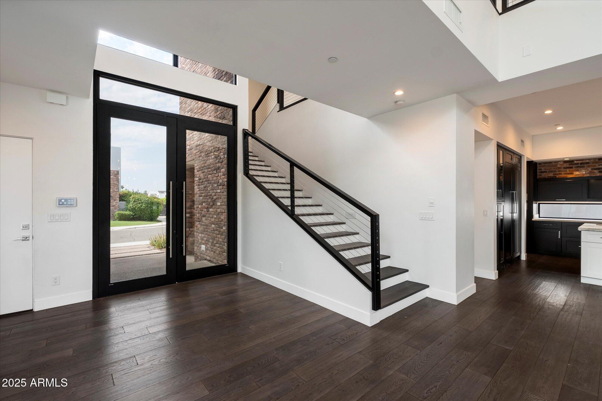 4525 North 36th Way Phoenix, AZ 85018 - Photo 5 of 40 a view of a hallway with wooden floor and staircase