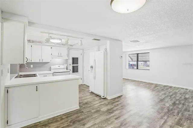 a view of a livingroom with a ceiling fan and window