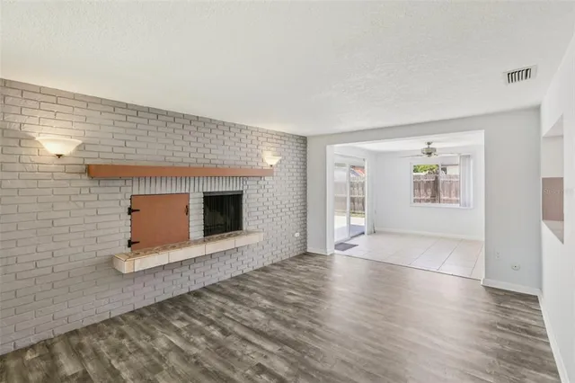 a kitchen with a sink cabinets and wooden floor