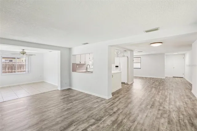 a view of a room with a wooden floor and a window