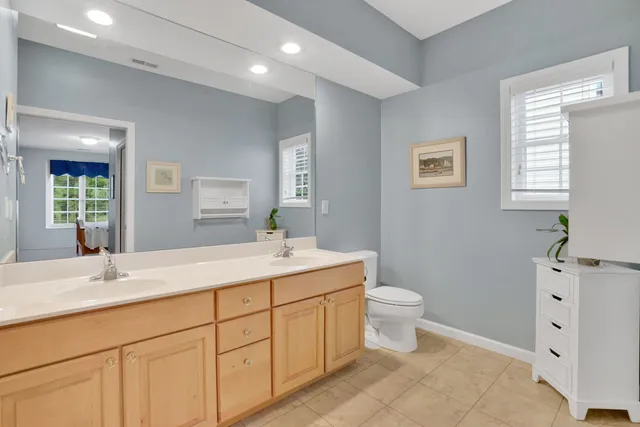 a bathroom with a double vanity sink a mirror and a shower