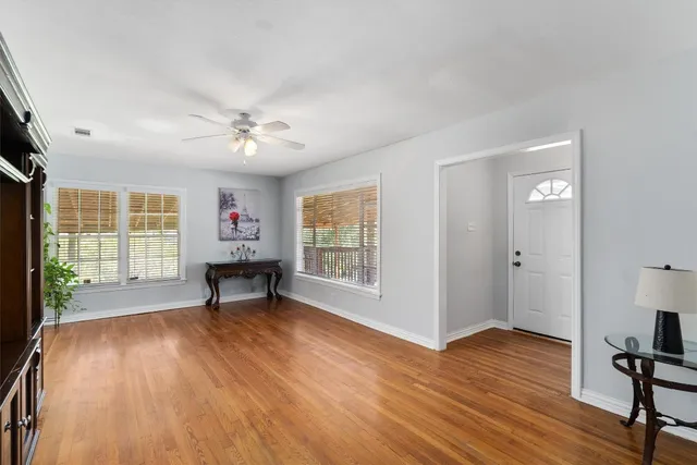 wooden floor in an empty room with a window