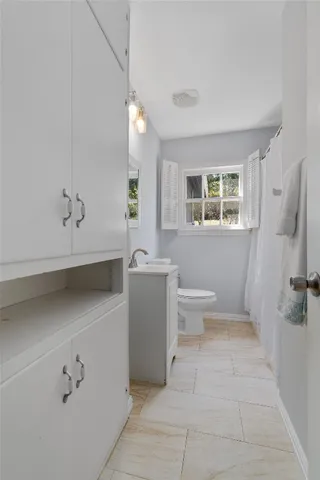 a bathroom with a sink toilet and shower