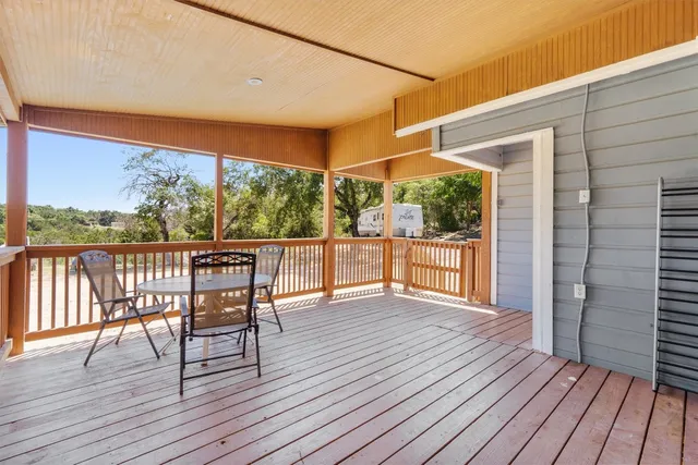 a view of a balcony with wooden floor