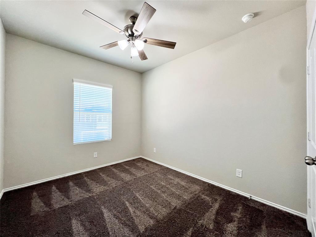 3501 East Renfro Street, Unit 121 Burleson, TX 76028 - Photo 32 of 35 an empty room with a chandelier fan and windows