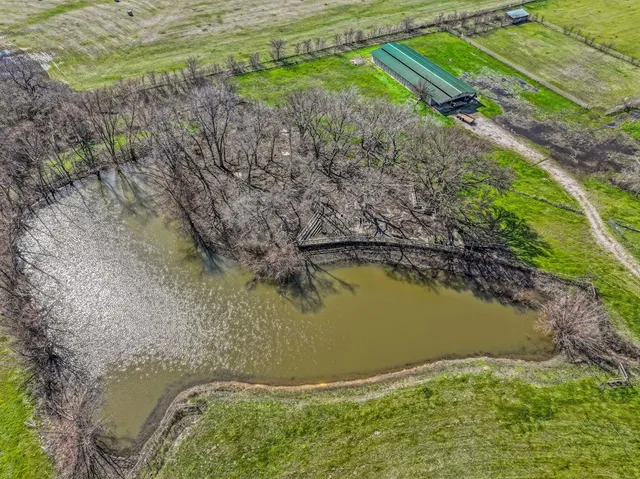 a view of a pool in a backyard
