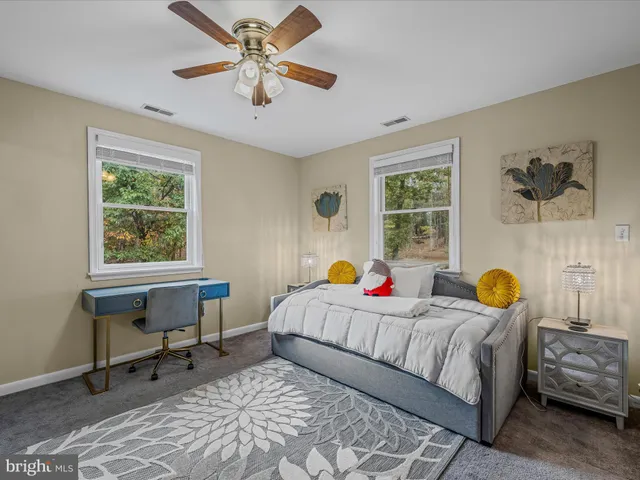 a bathroom with a granite countertop sink a toilet and shower