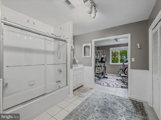 a living room with furniture a table and large windows