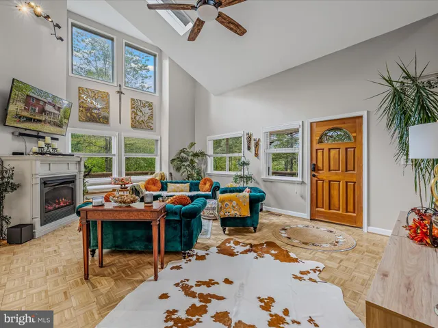 a living room with furniture a fireplace and a flat screen tv
