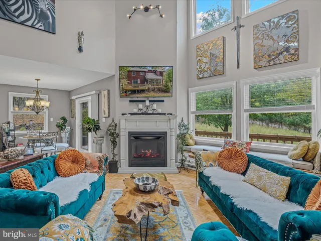 a living room with furniture fireplace and a large window