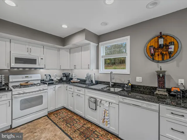 a kitchen with stainless steel appliances a sink stove and cabinets