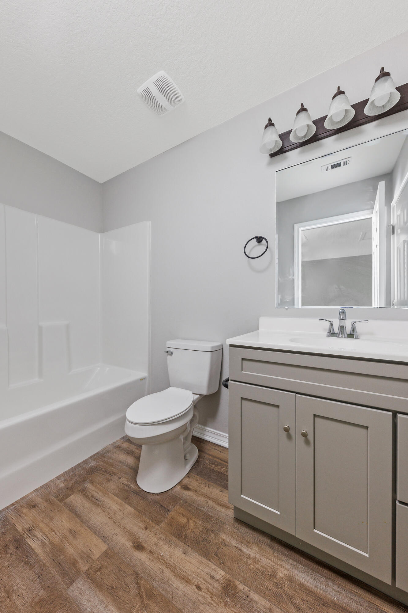 1207 Walter Avenue Crestview, FL 32536 - Photo 13 of 23 a bathroom with a toilet a sink a mirror and a bathtub