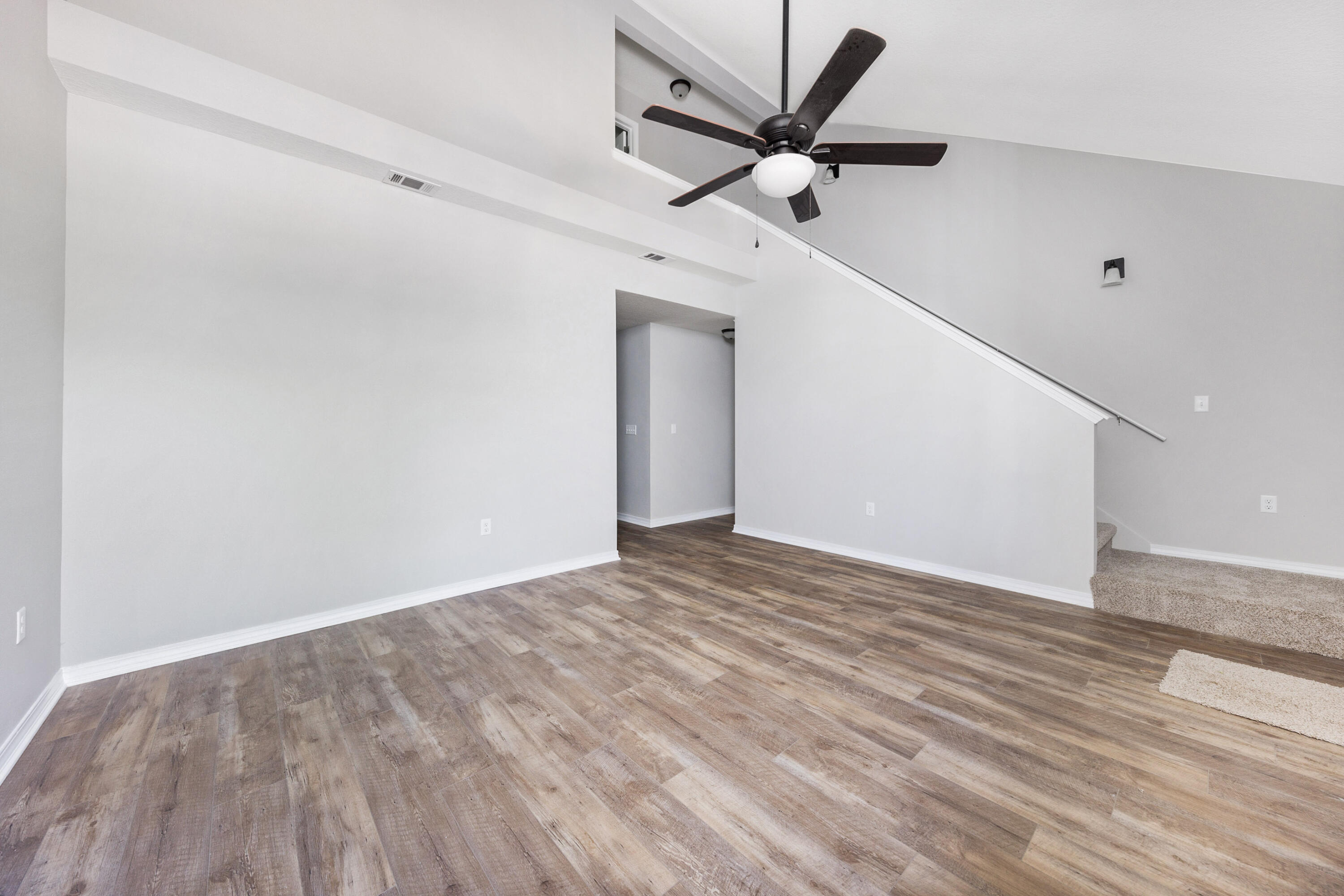 1207 Walter Avenue Crestview, FL 32536 - Photo 5 of 23 a view of a big room with wooden floor and a ceiling fan