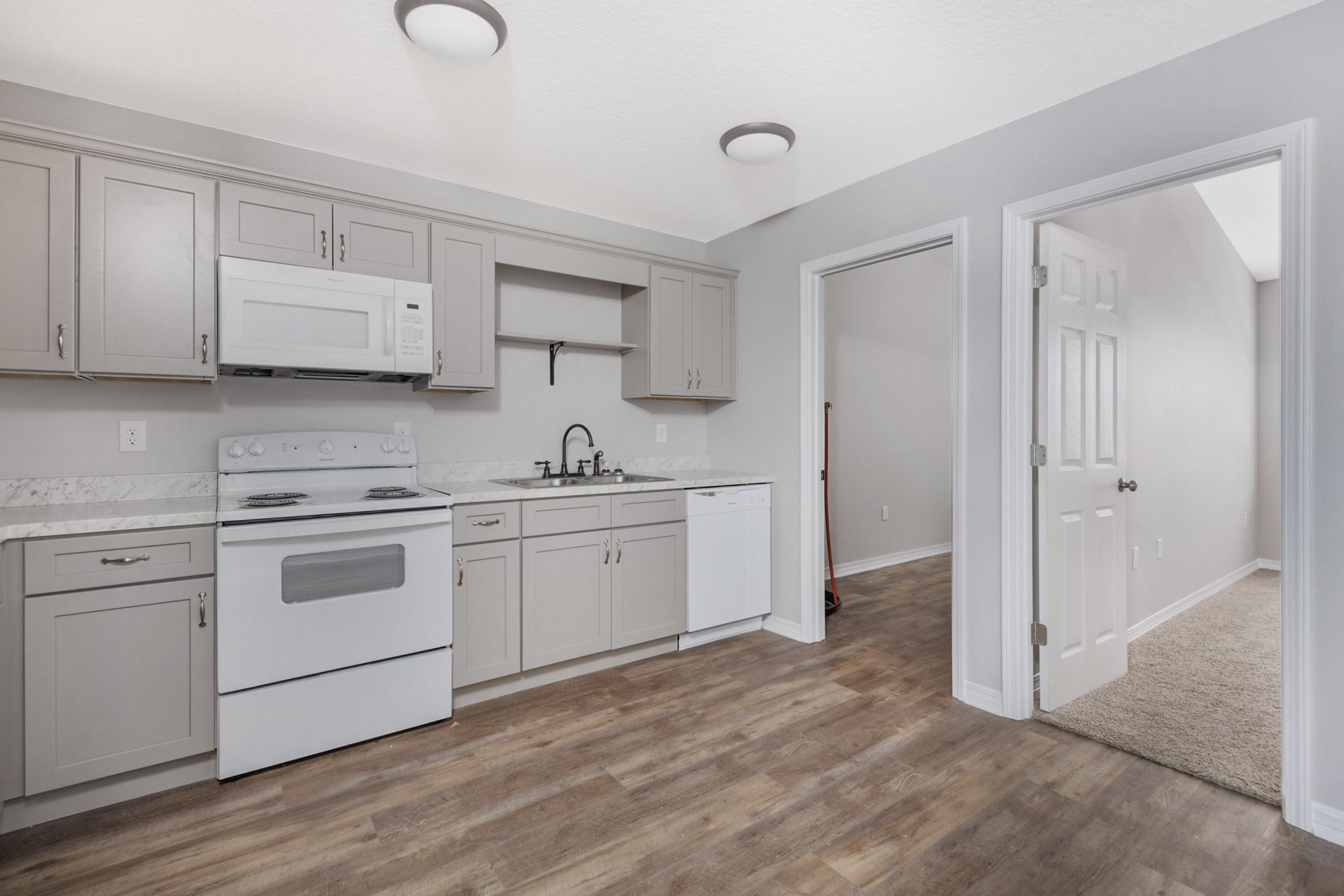 1207 Walter Avenue Crestview, FL 32536 - Photo 7 of 23 a kitchen with white cabinets and white appliances