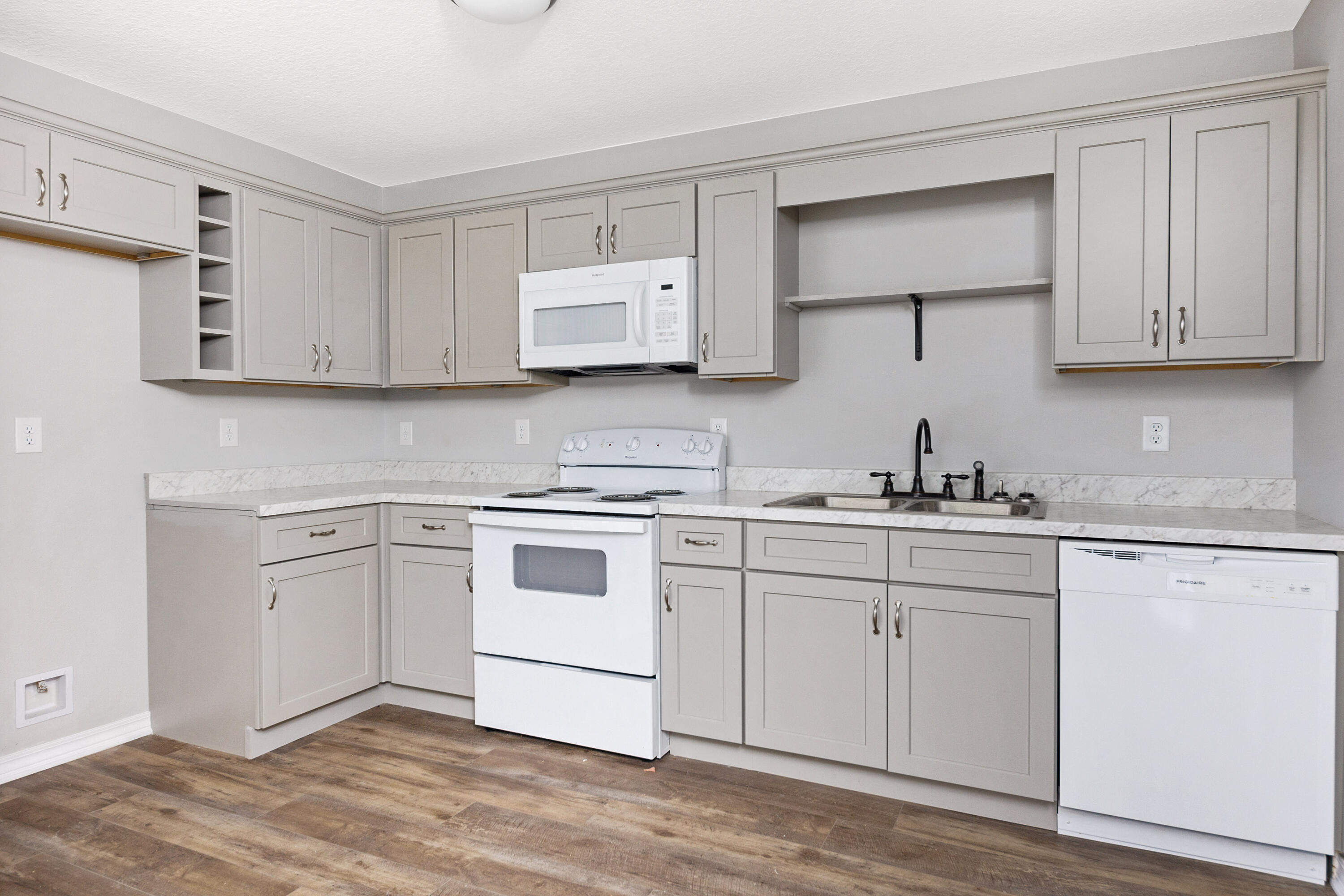 1207 Walter Avenue Crestview, FL 32536 - Photo 8 of 23 a kitchen with granite countertop white cabinets and white appliances