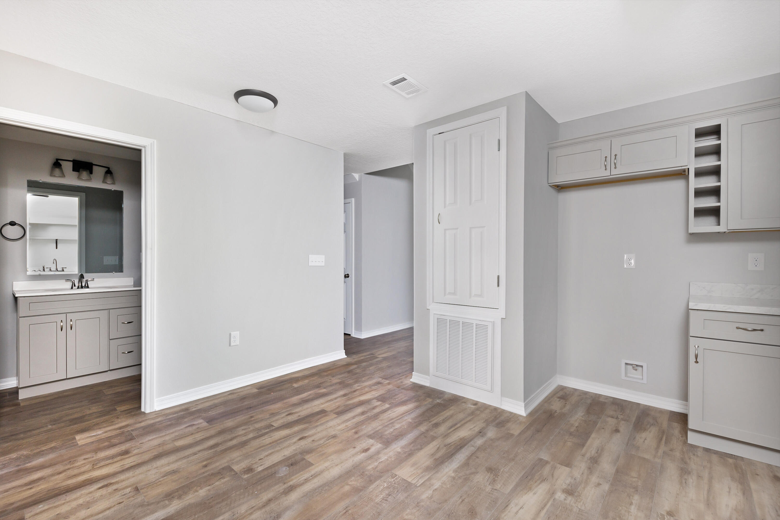 1207 Walter Avenue Crestview, FL 32536 - Photo 9 of 23 a view of an empty room with window and wooden floor
