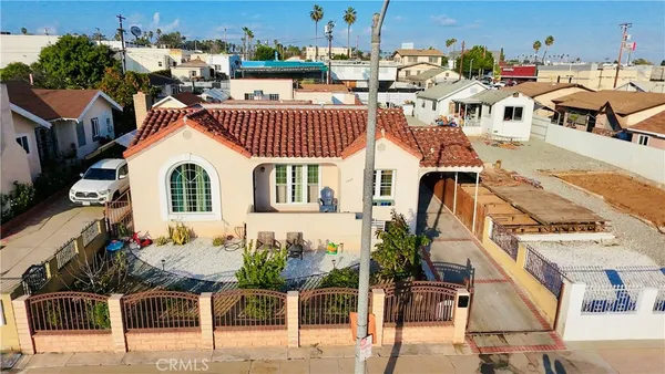 a view of a balcony with chairs potted plants
