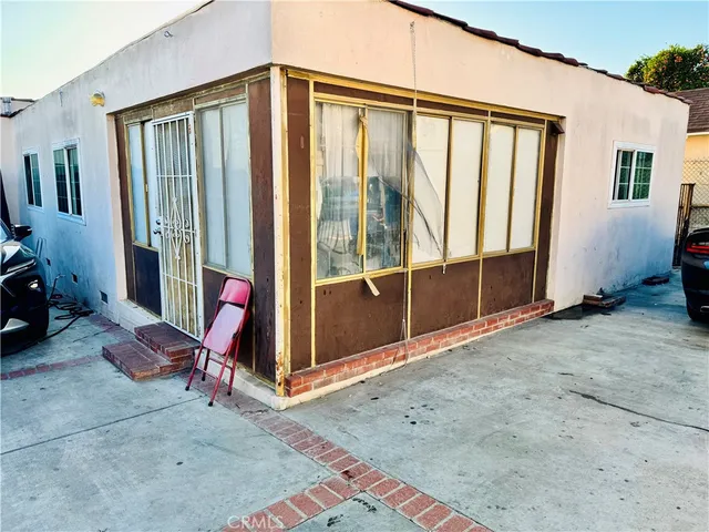 a view of a livingroom with wooden floor and furniture