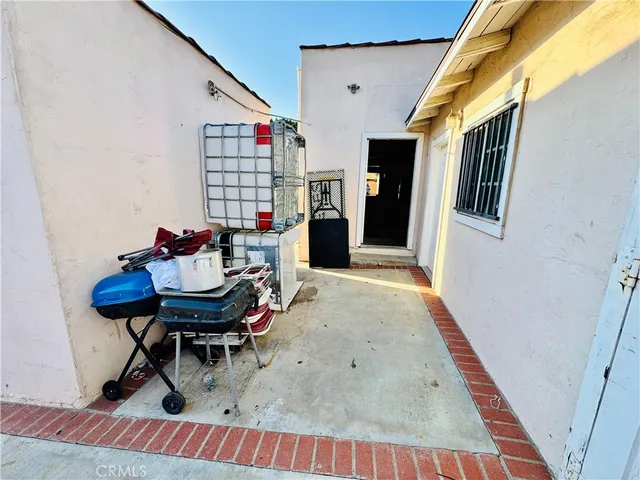 a view of a refrigerator in kitchen and an empty room
