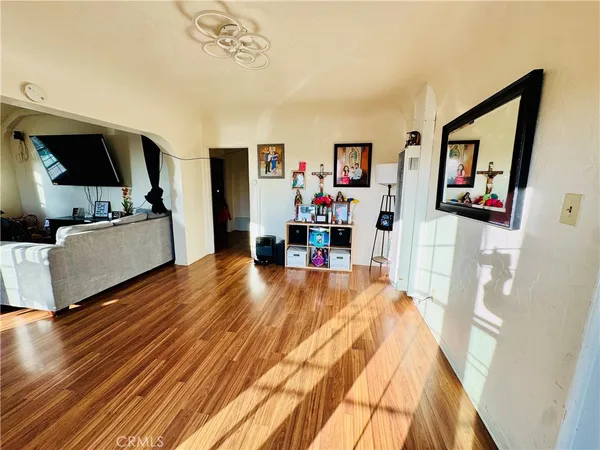 a living room with furniture and wooden floor