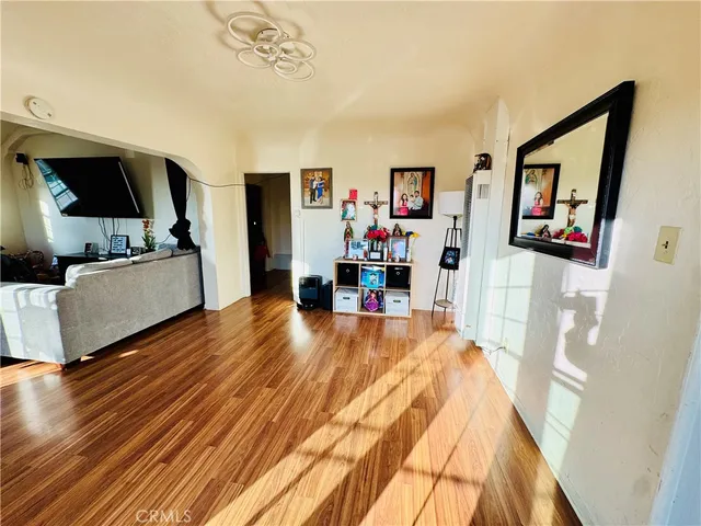 a living room with furniture and wooden floor