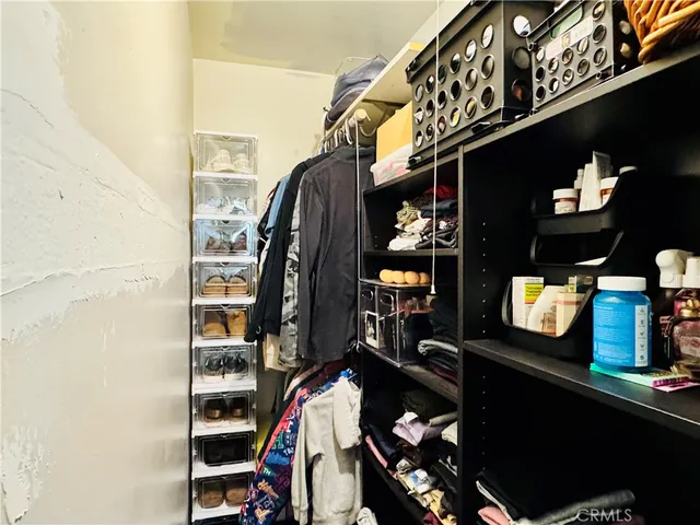 a kitchen with a refrigerator and a stove top oven