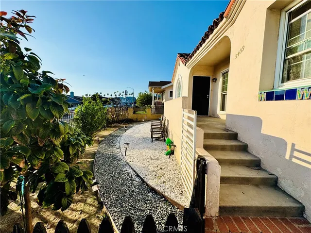 a view of a hallway with wooden floor and windows
