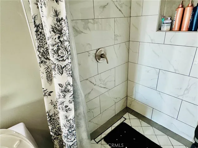 a bedroom with bed and a window