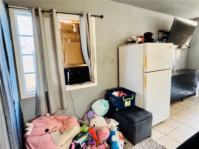 a room with green walls wooden floor and windows