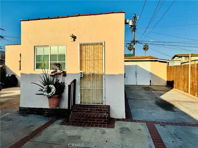 a backyard of a house with outdoor seating