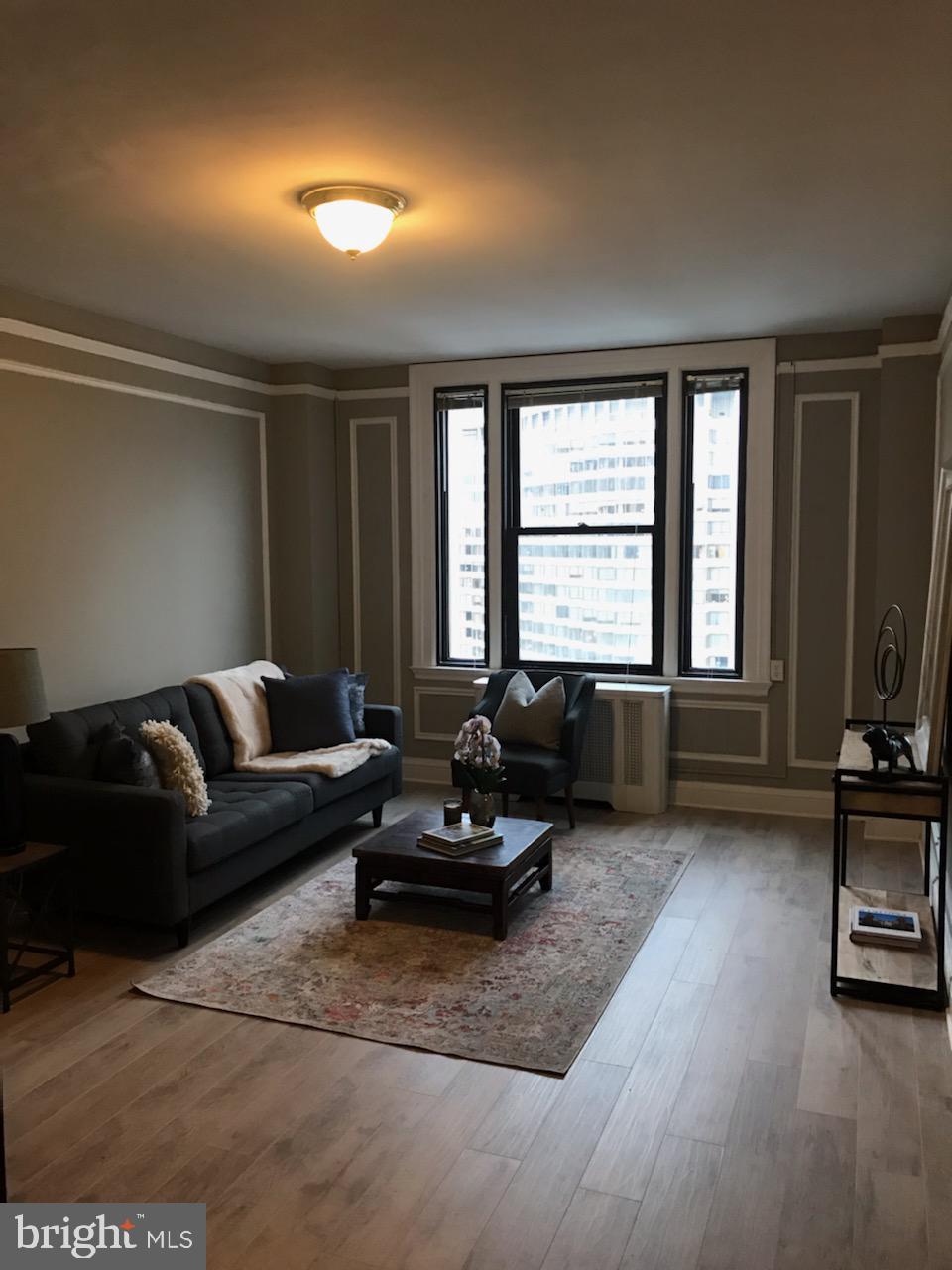 a living room with furniture window and a flat screen tv