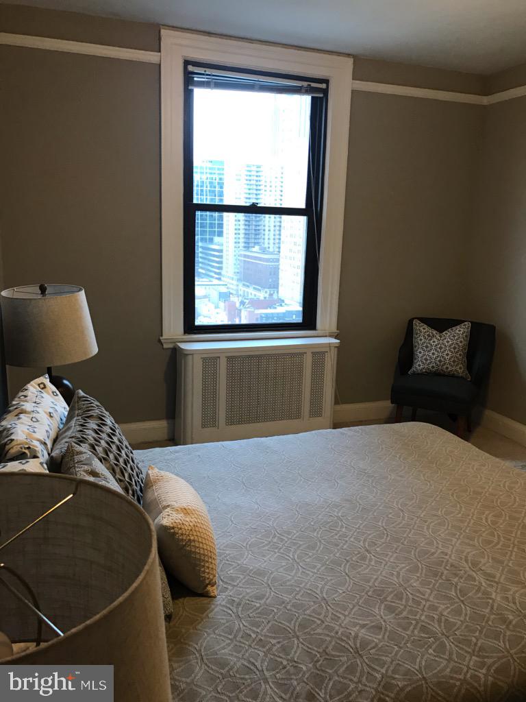 2031 Locust Street, Unit 1404 Philadelphia, PA 19103 - Photo 11 of 20 a bedroom with a bed and window