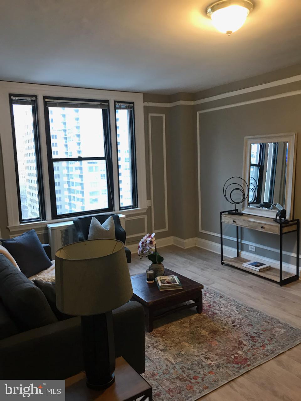 2031 Locust Street, Unit 1404 Philadelphia, PA 19103 - Photo 2 of 20 a living room with furniture and large windows