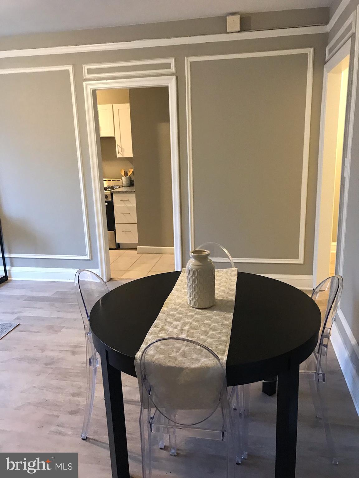 2031 Locust Street, Unit 1404 Philadelphia, PA 19103 - Photo 3 of 20 a view of a dining room with furniture and a window