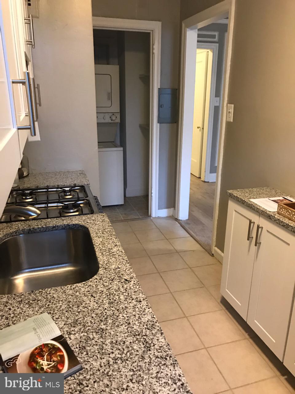 2031 Locust Street, Unit 1404 Philadelphia, PA 19103 - Photo 6 of 20 a kitchen with a sink stove and cabinets