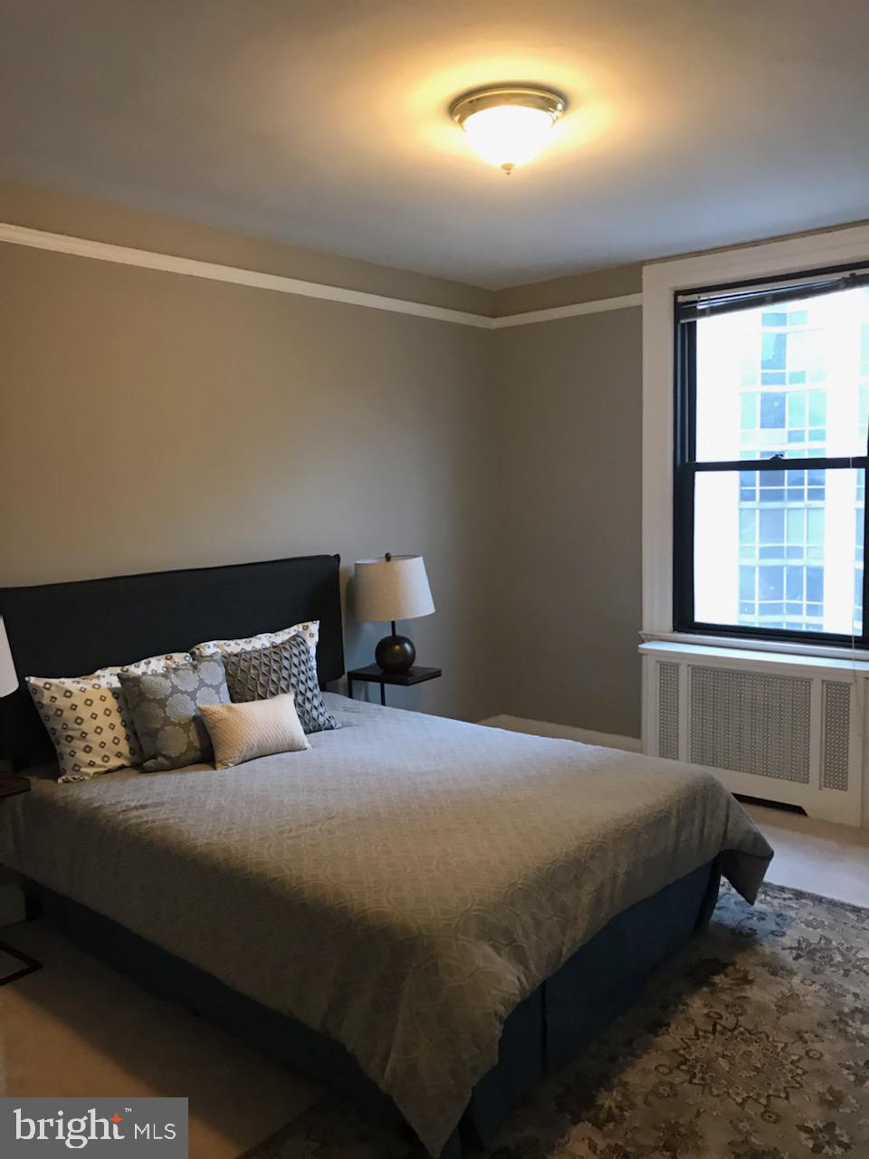 2031 Locust Street, Unit 1404 Philadelphia, PA 19103 - Photo 10 of 20 a bedroom with bed and window